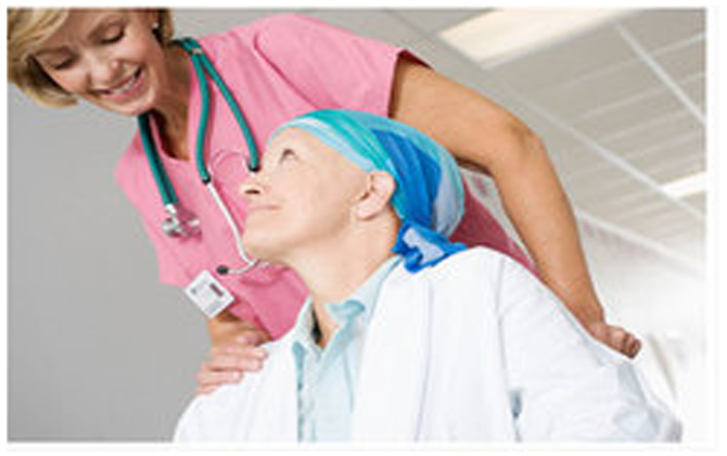 An old woman receiving treatment for cancer is supported by a nurse in a hospital environment