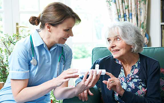An elderly woman receiving medication from a critical-care nurse assure her health and well-being