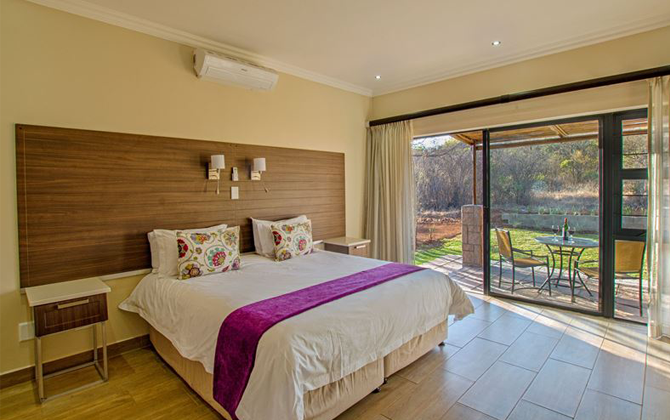 leisure accommodations include a peaceful bedroom with a large bed and glass sliding doors