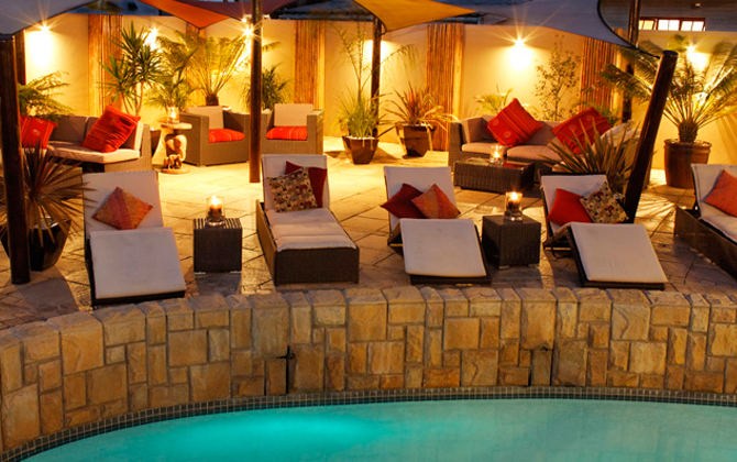 A delightful pool that blends in perfectly with a stone wall, providing a peaceful environment 