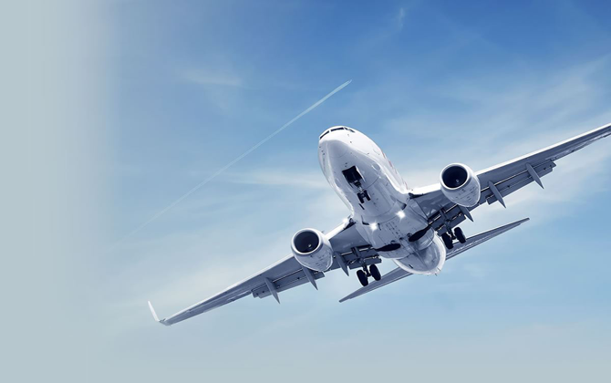 The image shows a big passenger jet in the air with the words Travel Assistance Services 