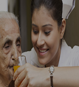 An aging woman is given orange juice by a kind nurse, showing the caring home healthcare services.