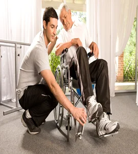 A man in a wheelchair assisting an elderly man in a wheelchair helping an older gentleman