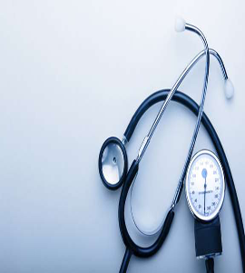 Stethoscope and blood pressure monitor with other medical equipment on a white background.