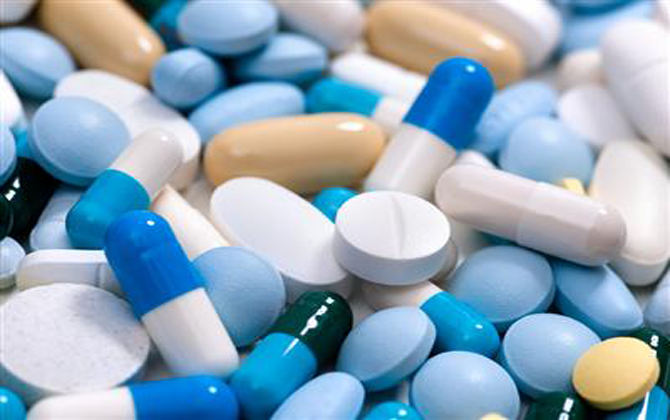 A pile of different pills and tablets represents the proposal for medicine delivery to homes